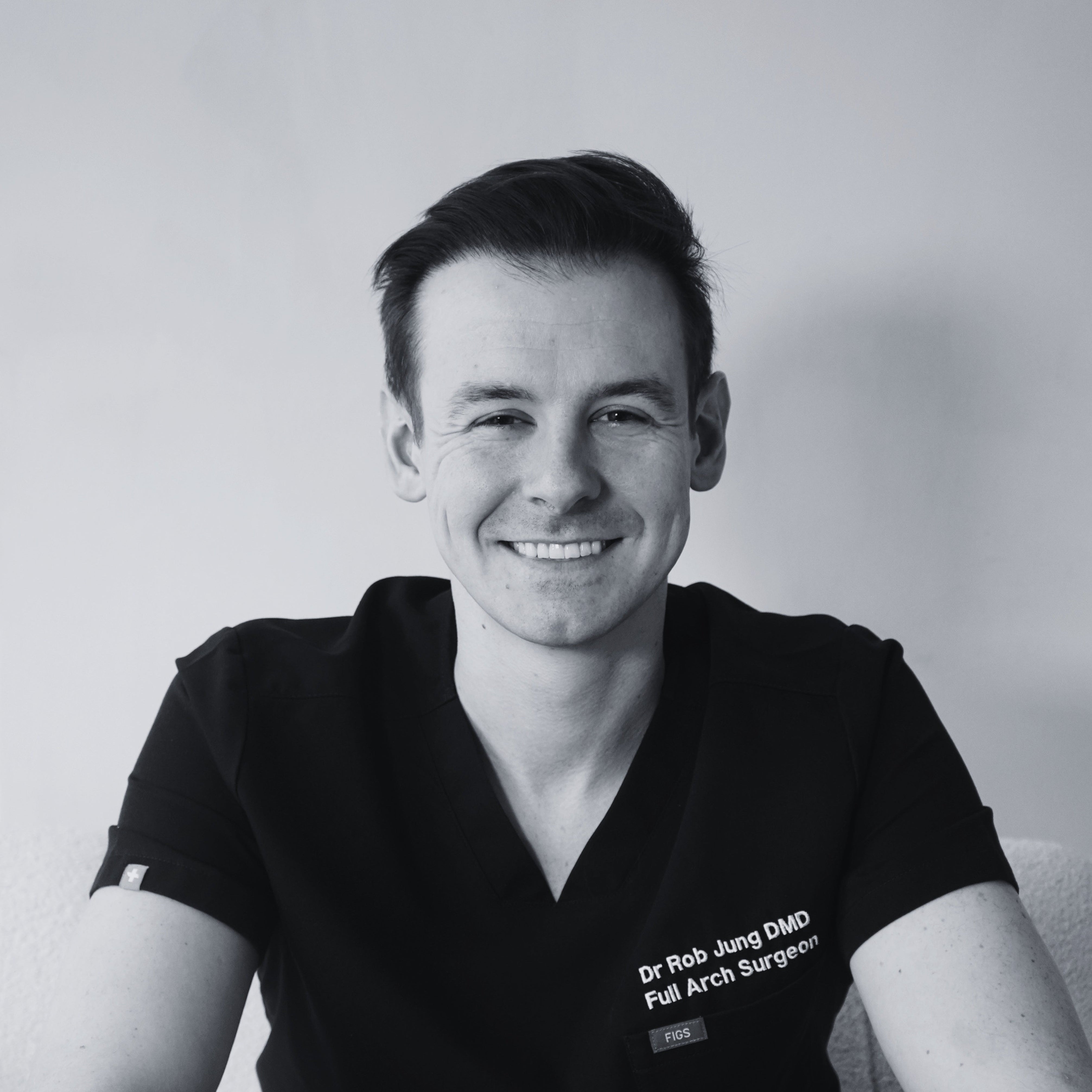 Black and white photo of a person wearing a medical uniform with text on a plain background
