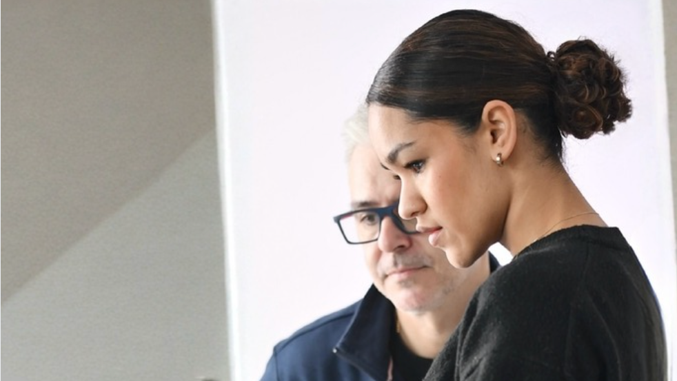 Two people looking at a tablet together in an indoor setting